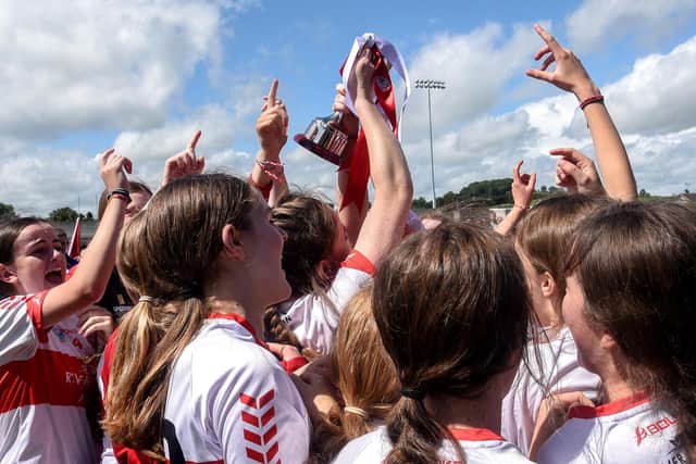 Derry players celebrate with the cup after the U16B Camogie All-Ireland Championship Final at Inniskeen Grattans Co. Monaghan. (INPHO/Ciaran Culligan)