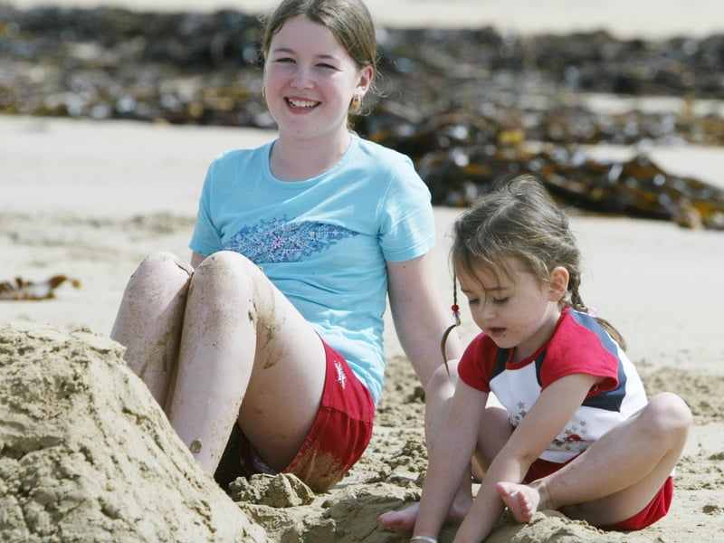 Donna and Stephanie Stewart from Dublin enjoying the sand at Ballyliffin. (0508JB70):Derry youngsters enjoying summer in August 2003