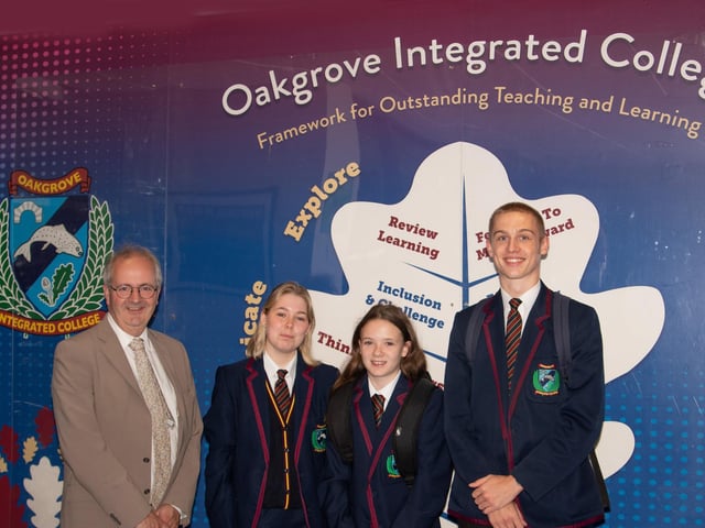 Year 8 student Roisin Healty being welcomed to Oakgrove College on Monday by Principal, Mr. John Harkin, Head Girl Brook Deery and Head Boy Bobby Skeggs . : Oakgrove Integrated College welcomes latest influx of Year 8 pupils