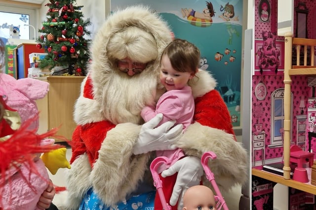 Two-year-old Bría McAteer from the Marlborough area of Derry was among those who were overjoyed when Santa paid a visit and came bearing gifts.
