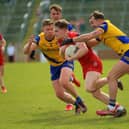 Roscommom’s Niall Daly and Ultan Harney grapple with Derry’s Ethan Doherty. Photo: George Sweeney