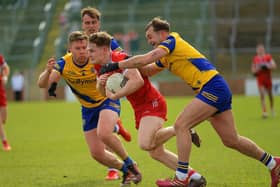 Roscommom’s Niall Daly and Ultan Harney grapple with Derry’s Ethan Doherty. Photo: George Sweeney