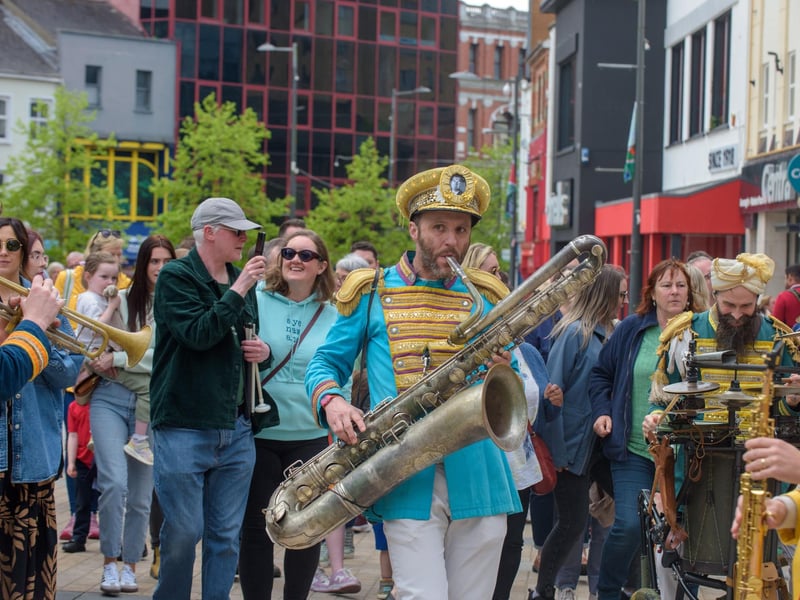 Mr Wilson’s Second Liners take to the streets of Derry as they add a jazz twist to pop music as they make their way round the city centre and into Guildhall Square . Picture Martin McKeown. 03.05.24