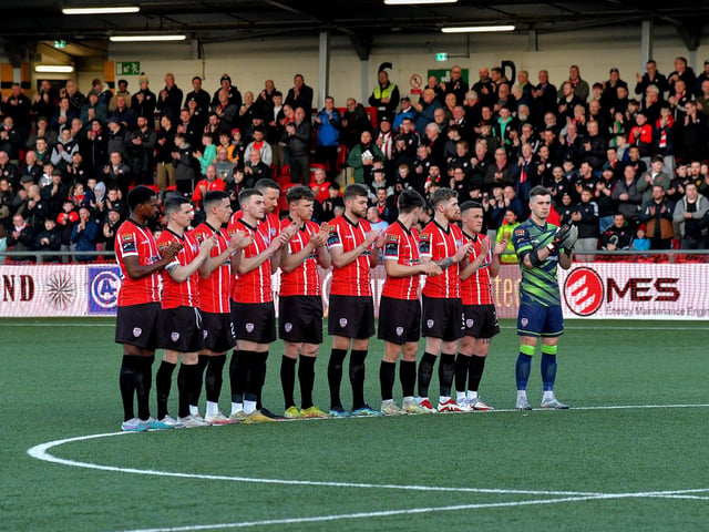 Derry City players take part in a one minutes applause for Jack McCauley, a former director of the club, who died recently . Photo: George Sweeney.  DER2314GS – 19
