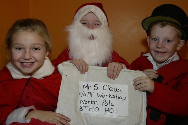 Model PS pupils Fiona Nelis, Zak Chester and Patrick Slevin who are the principal acotors in the schools nativity play "The Jolly Postman". (0912JB08):Derry nativities and Christmas shows from December 2003