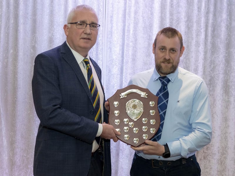 Glen McCallan of Sion Mills receives the League One bowling award from Brian Dougherty