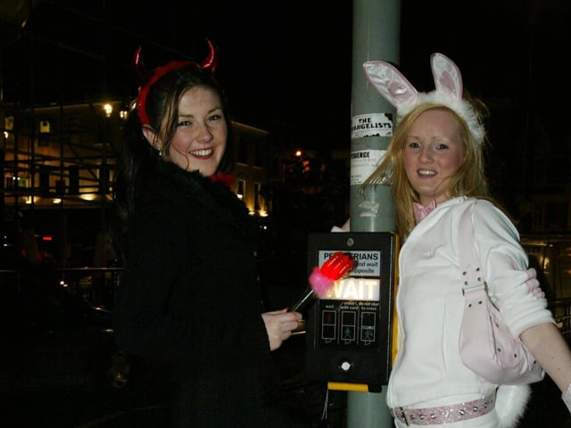 Stop the Lights..... Chalrene Curran and Natalie Duffy stop the traffic as they cross the road.  (0311JB50):20 YEARS ON: Halloween celebrations in Derry in 2003