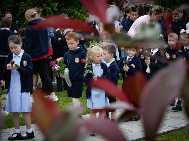 Some of the younger pupils make their way up to law flowers at the St. Mary's Church Grotton. (Photos: Jim McCafferty Photography)