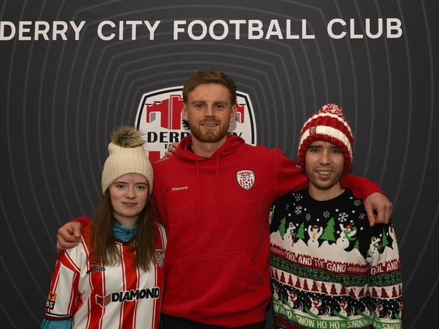 Candystripe fans Aoibheann and Donal Dunleavy pictured with Derry City's Rob Slevin at the club's merchandise outlet in Foyleside Shopping Centre. Photo: George Sweeney