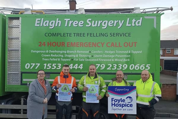 Kathleen Bradley, Fundraising Officer, pictured with the hard-working team at Elagh Tree Surgery, who volunteer their services to repurpose your used Christmas trees on Foyle Hospice grounds.