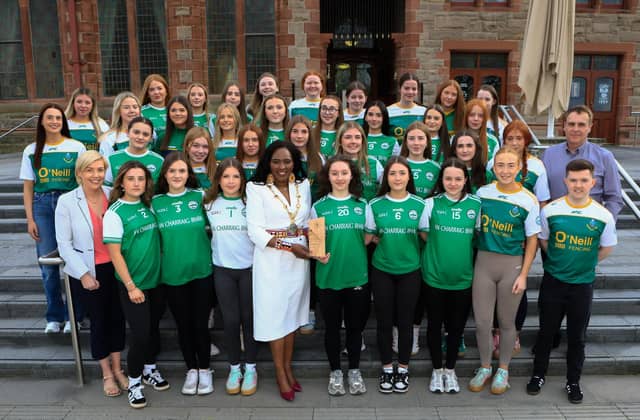 Mayor Lilian Seenoi Barr makes a presentation to members of Craigbane GAC and Clann na nGael GAC at a reception held in the Guildhall. Included is Cllr Fergal Leonard. (Photo - Tom Heaney, nwpresspics)