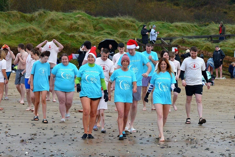 Swimmers make their way to the sea during the annual Christmas morning charity swim at Ludden beach, Buncrana. Photo: George Sweeney. DER2252GS – 22