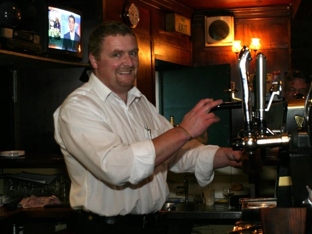 Pouring a pint in Tinney's in June 2004.