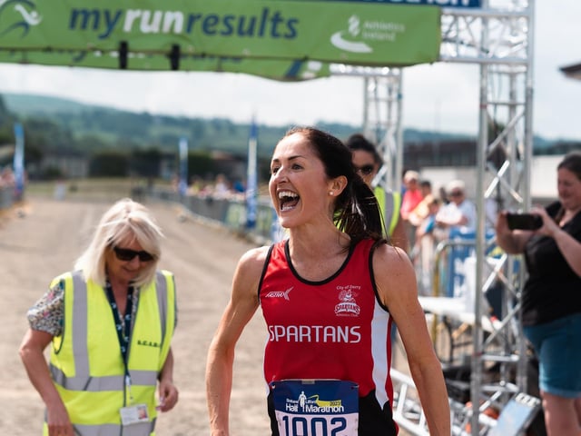 Women's winner Catherine Whoriskey is delighted to cross the finishing line in first place. (Photo: Karol McGonigle)