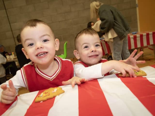 Three years-old Ollie and Kai McDonald enjoying some gingerbread men at Saturday's 'Christmas Get Together' at Long Tower Youth Club. : .