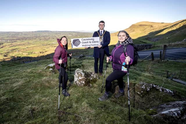 Mayor of Causeway Coast and Glens, Councillor Ciarán McQuillan pictured with Clare Quinn, Council Trade Engagement Officer and Mairéad Whall, Far and Wild at the launch of the 2025 Causeway Coast and Glens Walking Festival.