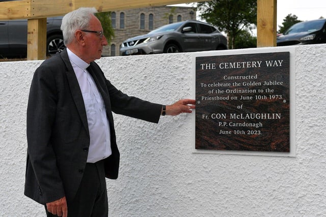 Fr Con McLaughlin PP, pictured alongside a plaque, erected by parishioners, in the grounds of the Church of the Sacred Heart, Carndonagh, on Saturday evening, to mark the occasion of his Golden Jubilee in the priesthood.  Photo: George Sweeney. DER2323GS – 169