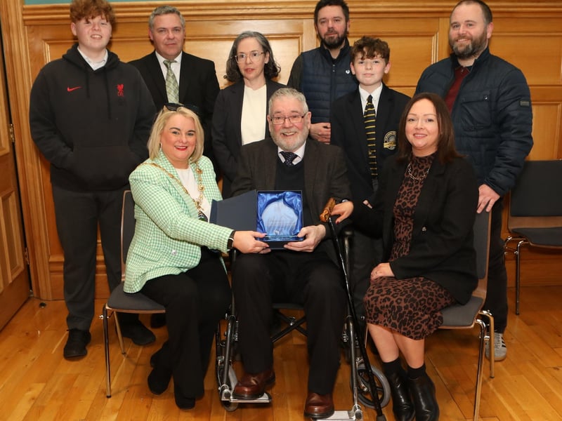 Mayor Sandra Duffy making a presentation to sculptor Maurice Harron, in recognition of his contribution as an art educator and artist in the City and District at a civic reception held in the Guildhall. Included are his children and grandchildren. (Photo - Tom Heaney, nwpresspics)