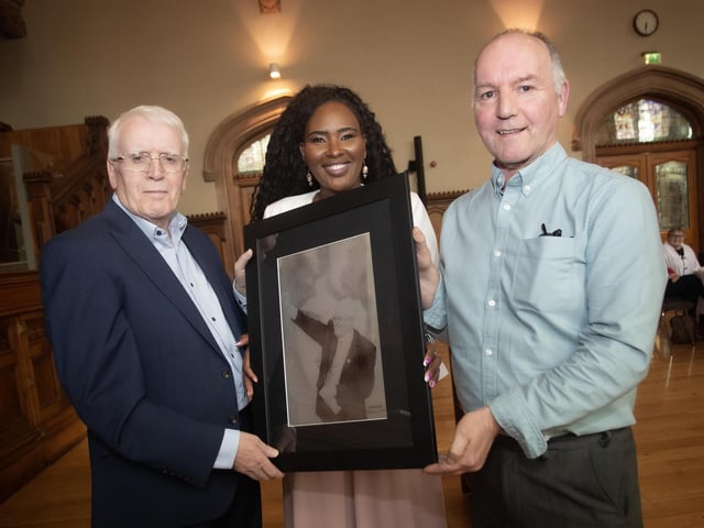 Tony Doherty, (right), chair, Bloody Sunday Trust, makes a special presentation to John Kelly at Monday's reception in the Guildhall. Included centre is the Mayor of Derry City and Strabane District Council, Lillian Seenoi-Barr.