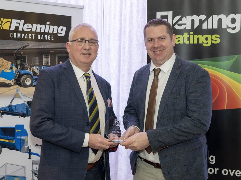 Jordan McGonigle of Donemana receives his 'Outstanding Contribution to Cricket' award from Brian Dougherty