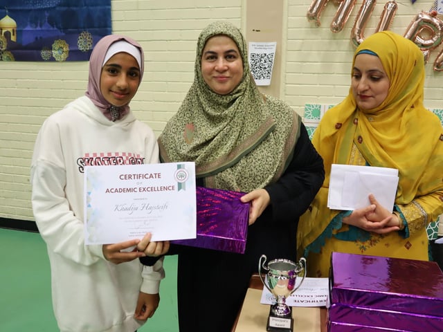 Khadija Hajsteifi receiving a Certificate of Academic Excellence during the Eid al-Adha celebrations.