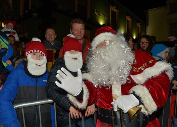 Santa pictured with familiar faces at the Christmas tree lights switch on in Buncrana on Friday evening last. Photo: George Sweeney. DER2247GS – 97