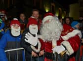 Santa pictured with familiar faces at the Christmas tree lights switch on in Buncrana on Friday evening last. Photo: George Sweeney. DER2247GS – 97