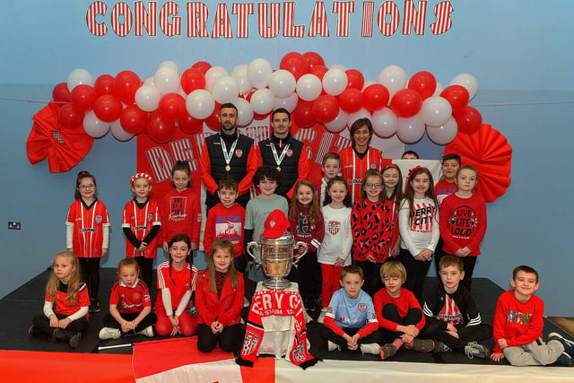 Derry City defenders Daniel Lafferty and Ciaran Coll pictured with Mrs Coyles P4 class and the FAI Cup at St Eithnes Primary School on Wednesday morning. Photo: George Sweeney.  DER2246GS  081