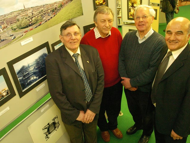 Gus Hastings, left, manager of Pilots Row, launches the Eden Place Arts Centre Camera Club exhibition which will run at the Central Library for two weeks. Included, from left, Michael McMenamin and Bobby White, Camera Club members, and Eamon Boast, Central Library. (2002PG30)