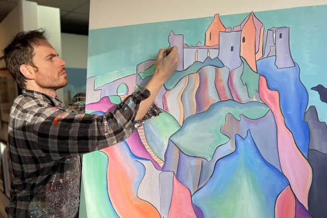Artist Adrian Margey painting Dunluce Castle.