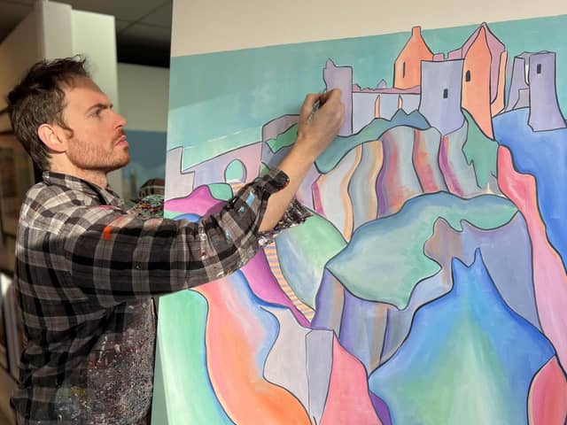 Artist Adrian Margey painting Dunluce Castle.