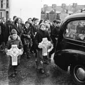 John Toland's children chief among the mourners making their way along Laburnum Terrace to the City Cemetery from St. Eugene's Cathedral following his Requiem Mass in 1976.