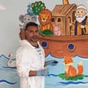 Iranian asylum seeker Alborz Nobakht painting the children’s area of Ballywillan Presbyterian Church.