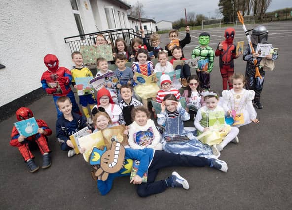 Happy children celebrating World Book Day at Hollybush PS on Thursday.