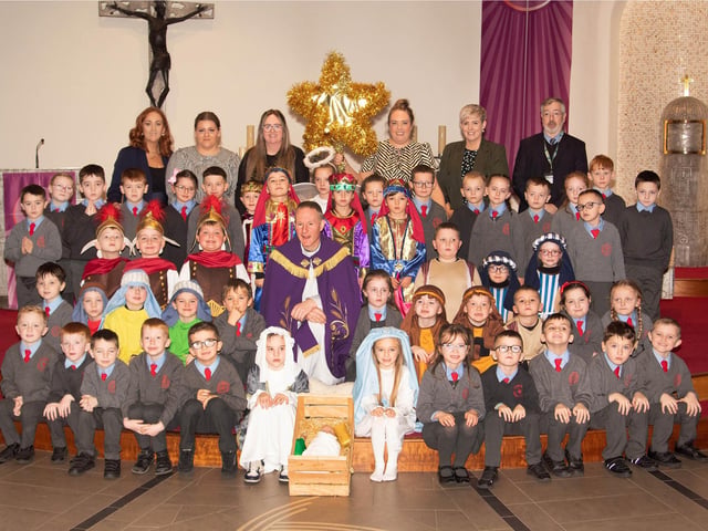 ST. BRIGID'S NATIVITY. . . . .Group pictured on the altar at St. Brigid's Church, Carnhill after Wednesday's St. Brigid's PS Nativity. Included are Mrs Tina. Ruddy, RE/Music Coordinator, Ms. Caitlín Kelly LSA. Mrs. Lynn McCay. Year 3 Teacher, Mrs. Caitríona Quigley, Year 3 Teacher, Mrs. Trudy McLaughlin LSA, Mr. Paul O'Doherty, Principal and Fr. Sean O'Donnell. (Photos: Jim McCafferty Photography)