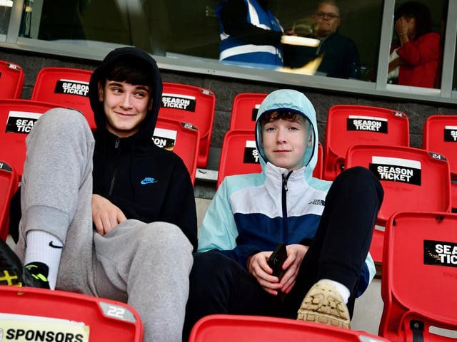 These two young fans in the Mark Farren Stand are waiting to be entertained by Ruaidhri Higgins' side.