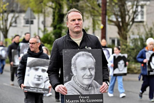 Fiachra McGuinness carries a photograph of his father Martin during commemoration of the 109th anniversary of the Easter Rising on Sunday afternoon. Photo: George Sweeney