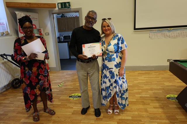 Sudanese national Khalid Ahmed collecting his certificate from Mayor Sandra Duffy and Lilian Seenoi Barr.