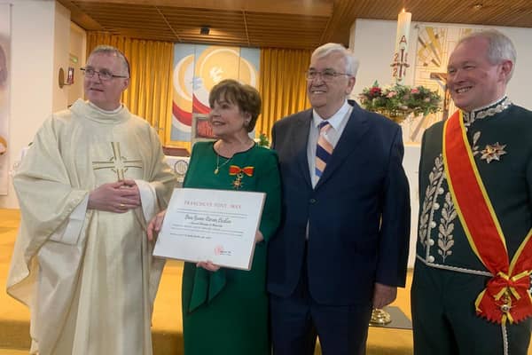 Dana with, from left, Bishop Michael Duignan, her husband Damien, with John McCaffery, President of the Irish Association of Papal Orders