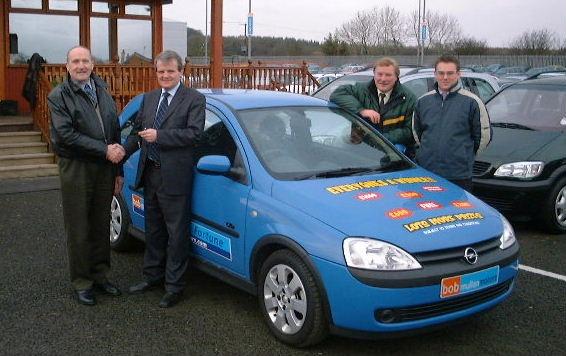 Bobby Mullan, right, presenting January 2003's draw winner Mr Alex Robinson from Limavady with the keys to his new Opel Corsa, which he won after he purchased a car from Bob Mullan Motors.