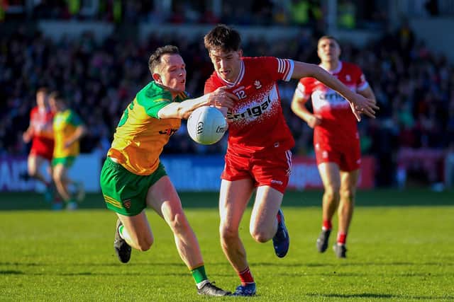 Donegal’s Aaron Doherty pursues Paul Cassidy of Derry. Photo: George Sweeney