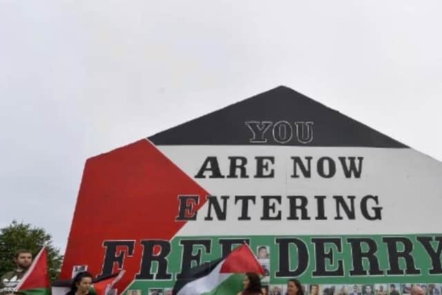 2018: Free Derry Corner painted in the colours of the flag of Palestine as pictured during a solidarity rally.