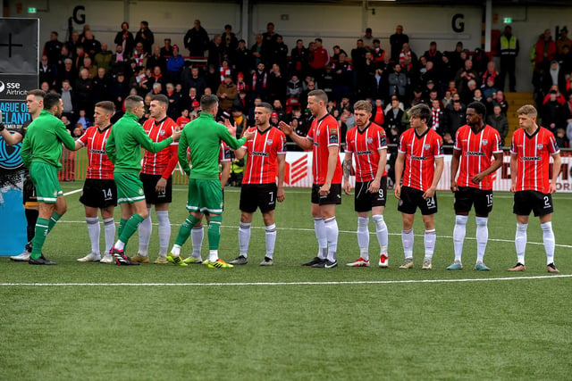 Derry City players welcome Shamrock Rovers players prior kick off on Monday evening. Photo: George Sweeney.  DER2318GS – 40