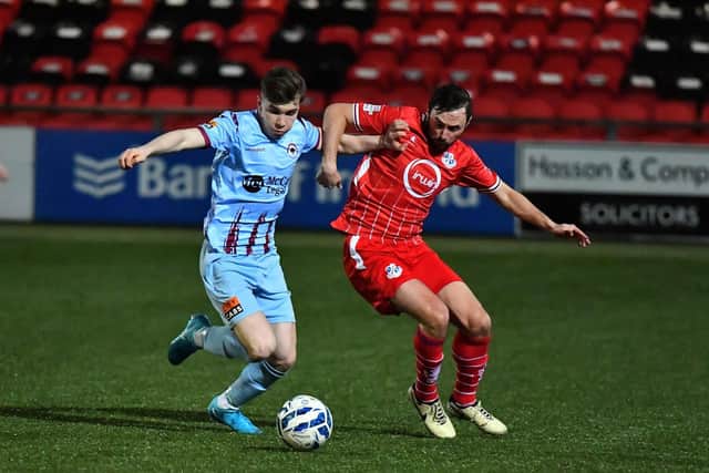 Institute’s Oisin Duffy shields the ball from Francis McCafferty of Lougghall. Photograph: George Sweeney
