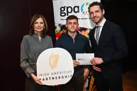 Derry's Eunan Mulholland is presented with their scholarship by Mary Sugrue, Chief Executive Officer, Irish American Partnership, and GPA Chief Executive Officer Tom Parsons, during the announcement of the GPA and Irish American Partnership 32 ‘Education Champion’ Scholarships at the Alex Hotel in Dublin. (Photo by Ramsey Cardy/Sportsfile)