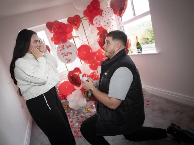 POP THE QUESTION !!!! . . . .Old Romantic Dylan Stafford gets down in one knee to propose to girlfriend Chelsea when they moved in to their new Braidwater Roe Wood home in Limavady on Valentine's Day. (Photo: Jim McCafferty Photography)