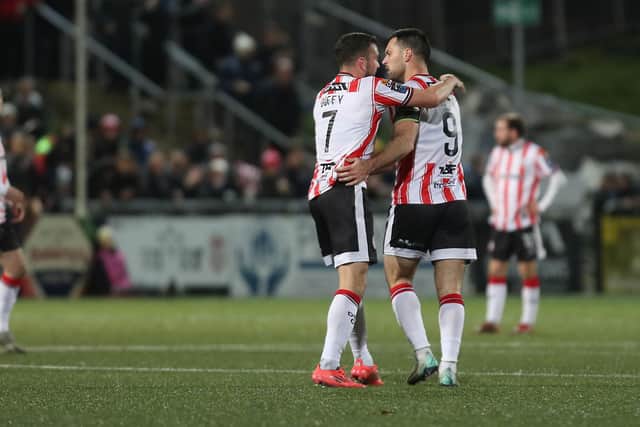 Derry City Pat Hoban celebrates a goal with Michael Duffy.