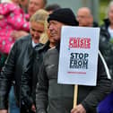Protester with a placard at a previous Derry Against Fuel Poverty march and rally. Photo: George Sweeney.  DER2239GS – 114