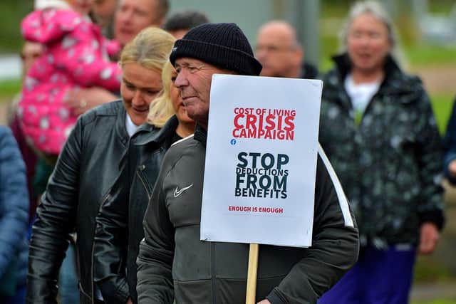 Protester with a placard at a previous Derry Against Fuel Poverty march and rally. Photo: George Sweeney. DER2239GS – 114