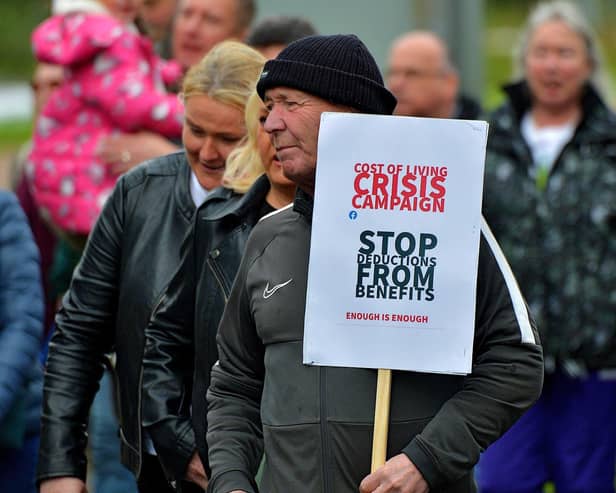 Protester with a placard at a previous Derry Against Fuel Poverty march and rally. Photo: George Sweeney.  DER2239GS – 114